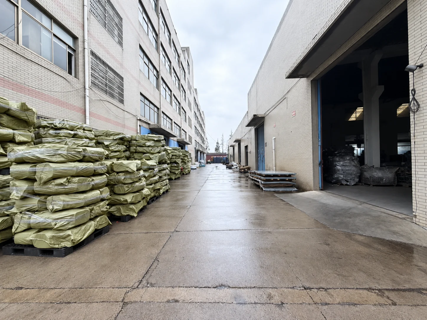 Access lane between factory buildings with stored components