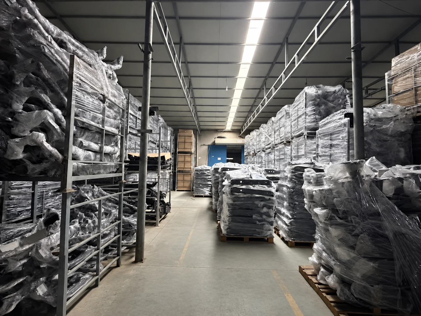 Central warehouse aisle lined with packed components